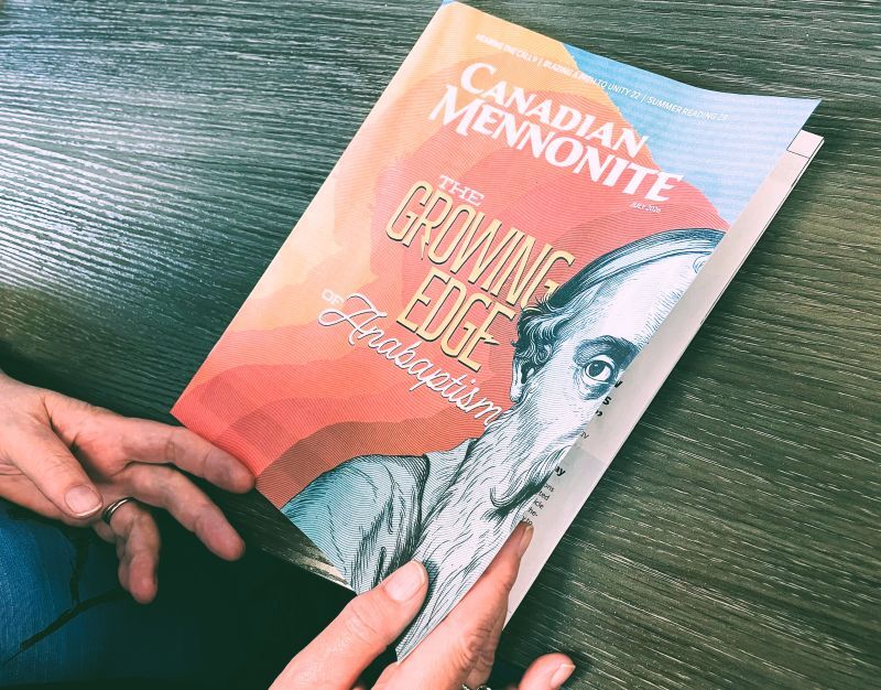 hands opening a magazine