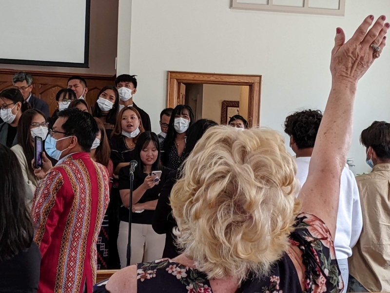 choirs leading worship, woman raising hands in worship