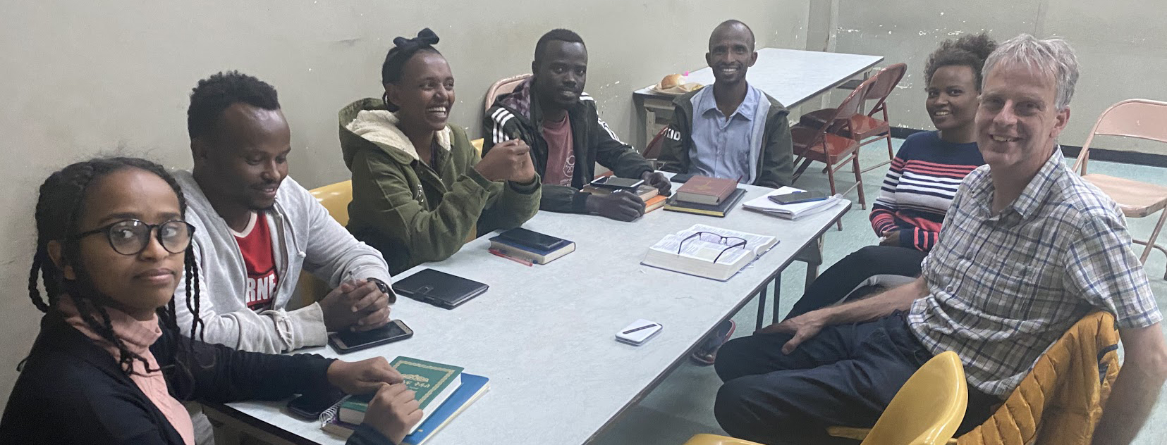 Students in Ethiopia sitting at table with their teacher